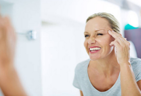 Old lady happy staring at the mirror